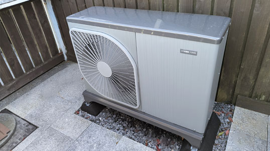 Air source heat pump installed outside a home in Swansea